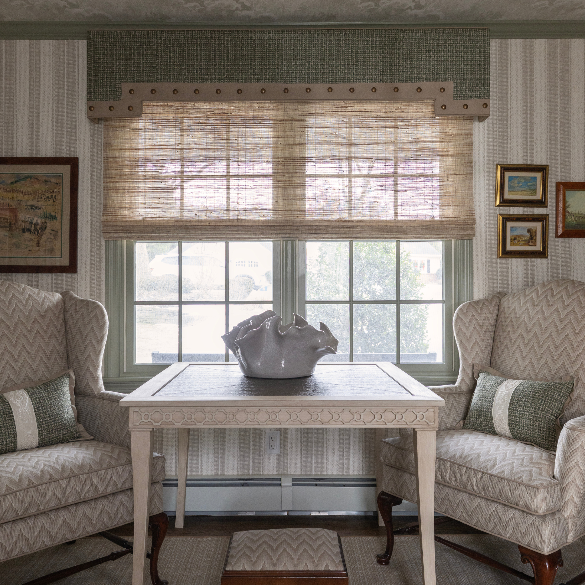 Living room corner with custom upholstered chairs, custom table, and custom window treatments by Peppard Home + Interiors in Huntington, NY